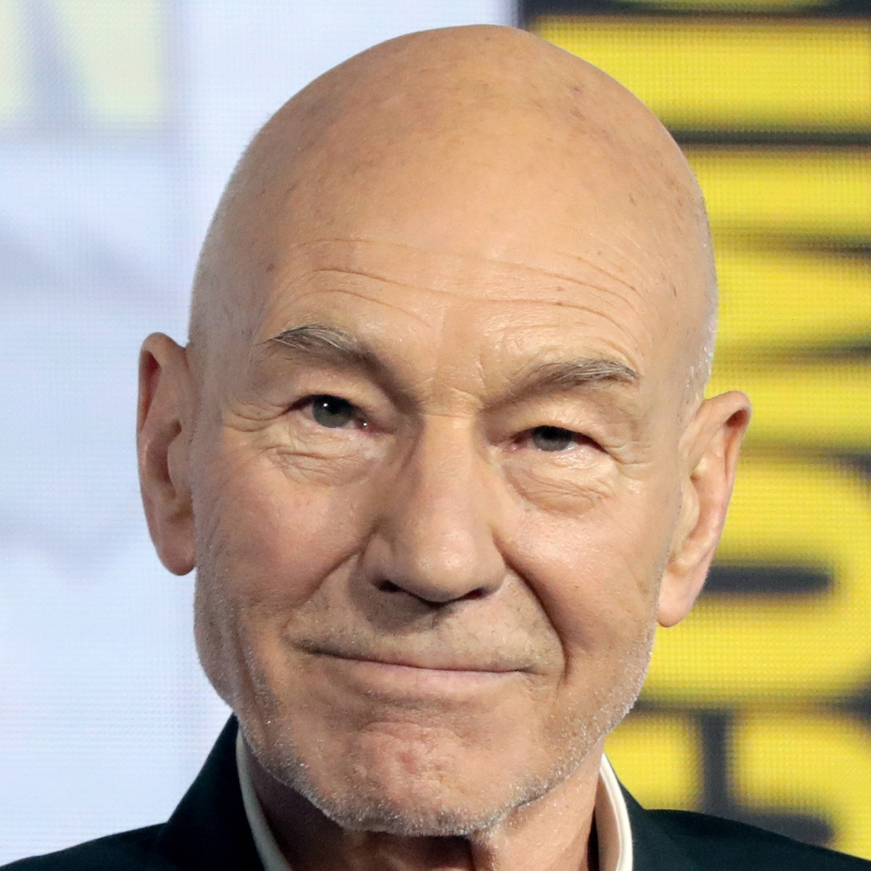 Sir Patrick Stewart smiling on a panel at San Diego Comic-Con in 2019